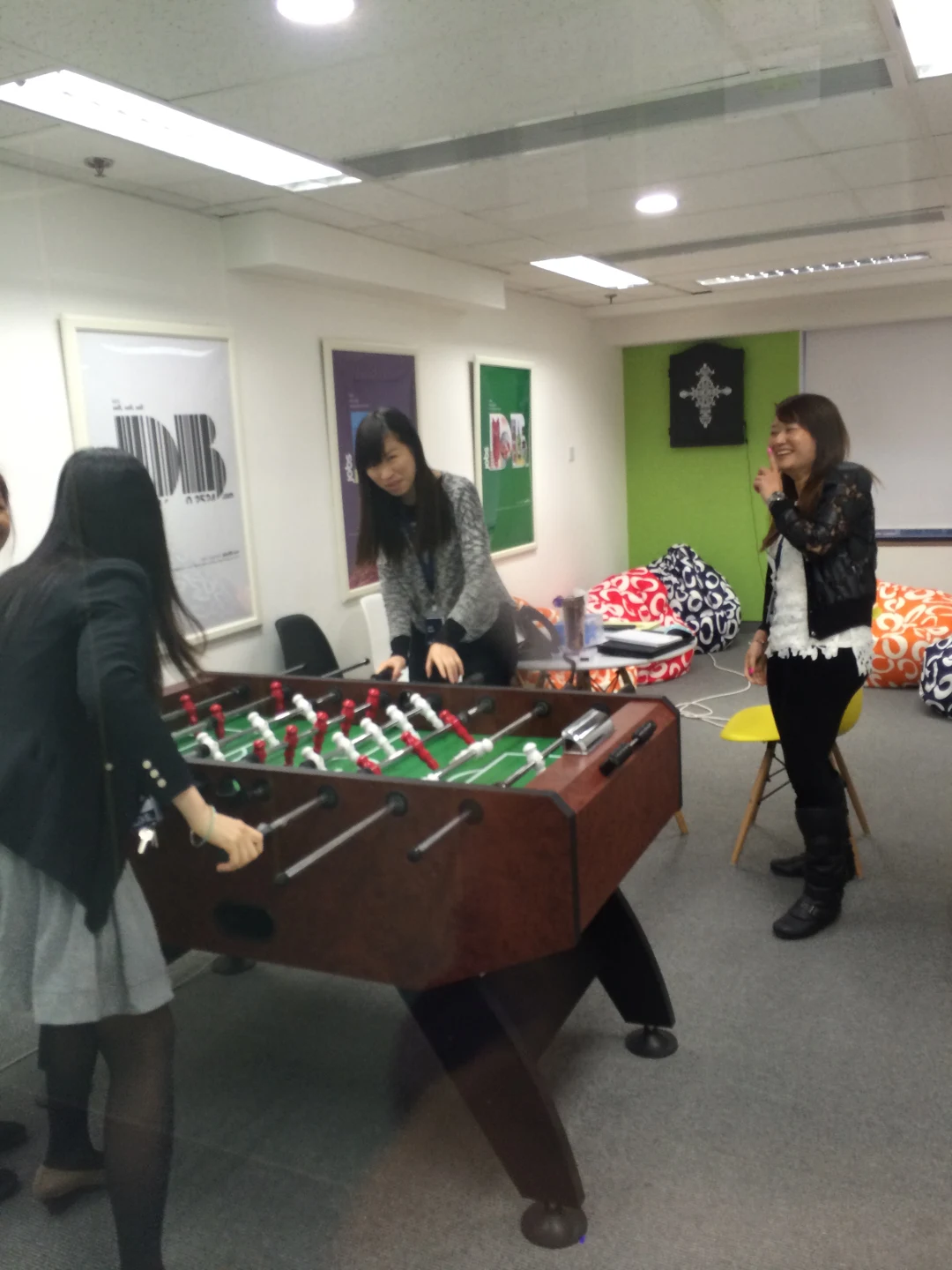 SEEK Asia colleagues around a table-football game in the office